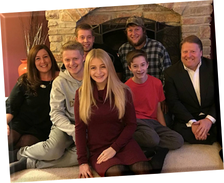Crane Family Photo by fireplace Saint Charles Illinois, Left to Right: Jennifer Braasch Crane, Bradley Crane, Billy Crane AKA Billy Biceps, Ashley Crane, Brian Crane, Brandon Crane, Bill Crane