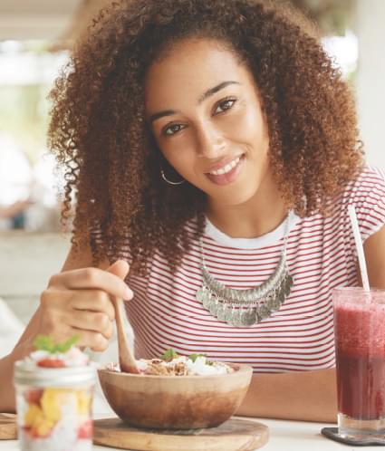 mom smiling eating healthy food