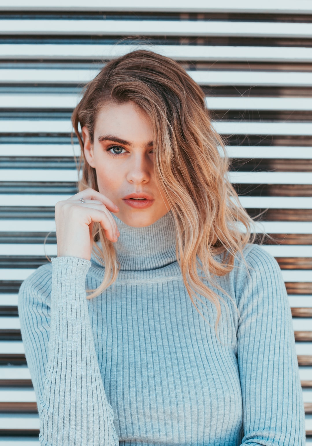 Woman in a fashionable grey top representing learning learning marketing for a fashion brand. 